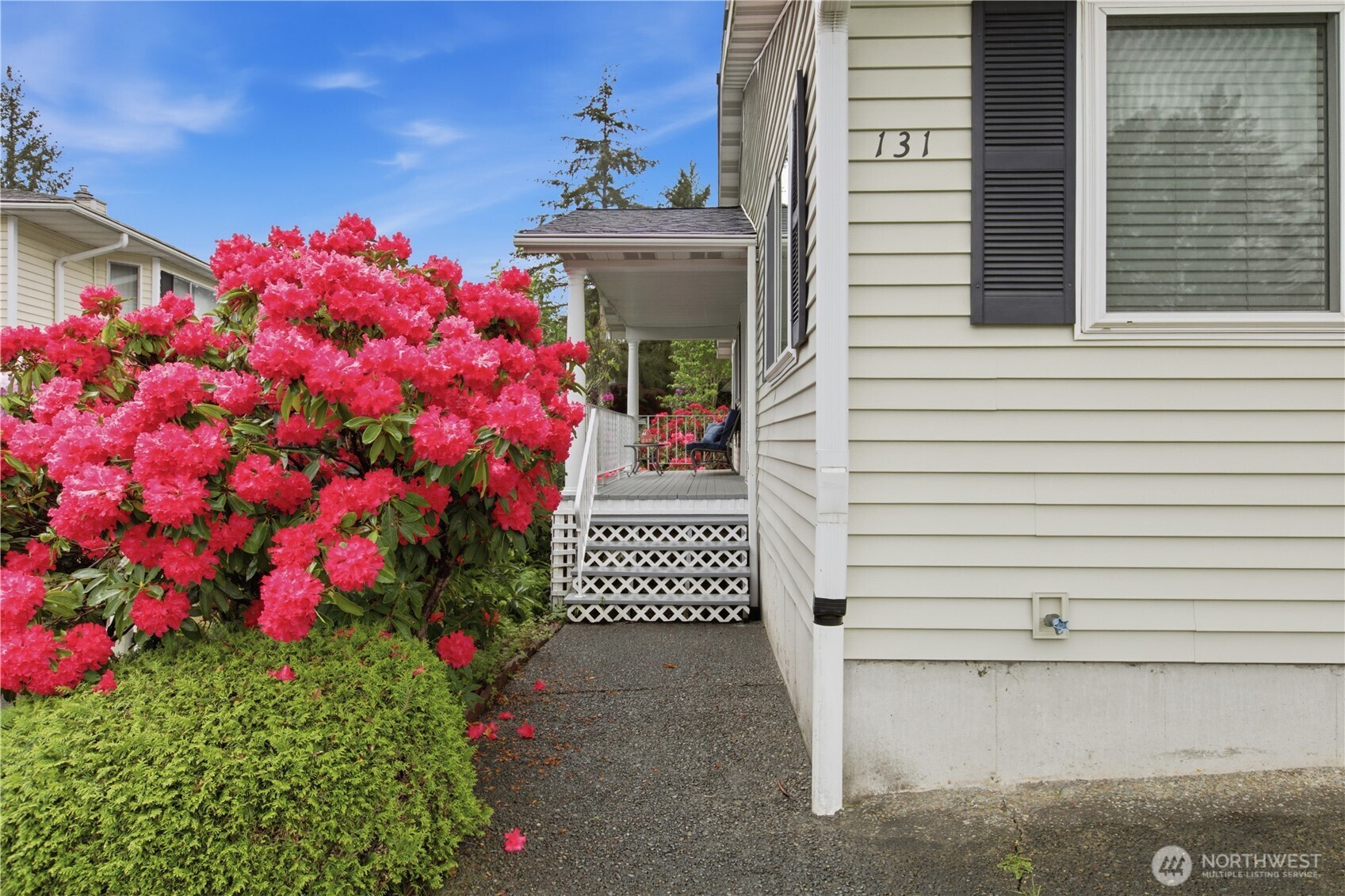 131 South 324th Place Federal Way, WA 98003 - Photo 21 of 24 a front view of a house with a flower garden