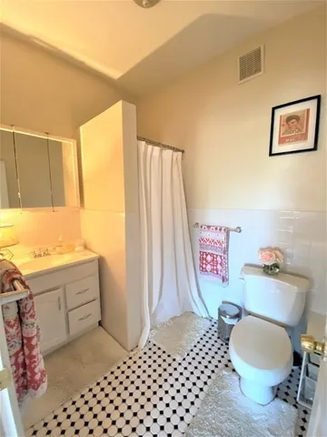 a bathroom with a sink mirror vanity and toilet
