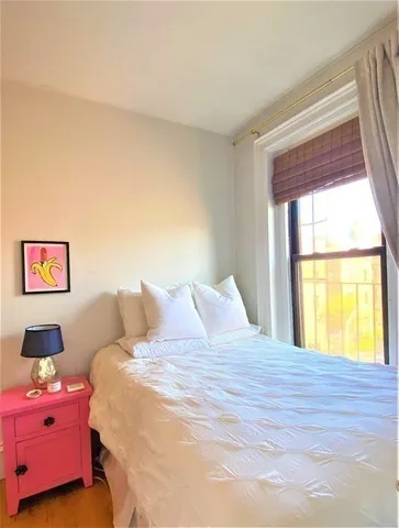 a bedroom with a bed and window