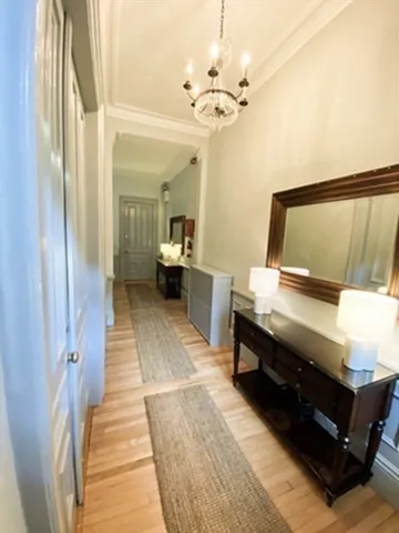 a living room with a bed furniture and a chandelier