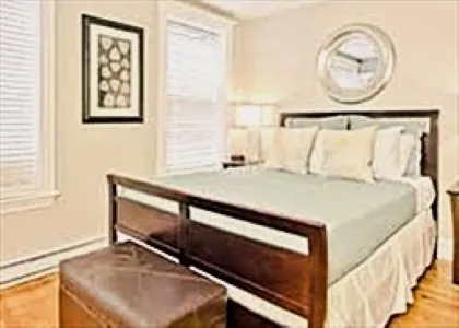 a bedroom with a bed and a window