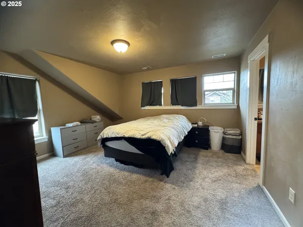 a spacious bedroom with a bed and a couch