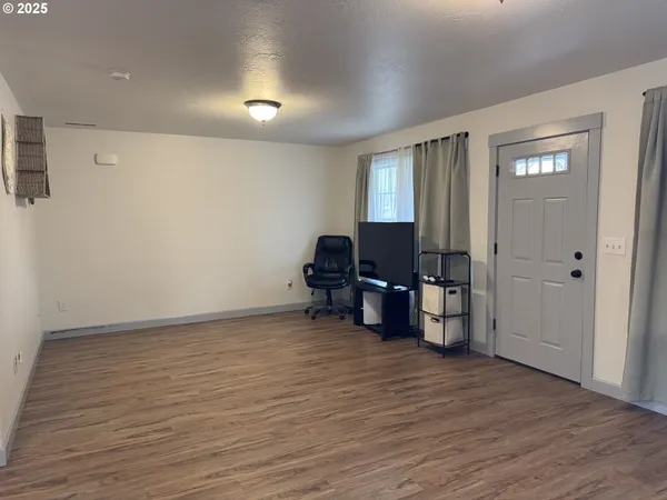 a view of a livingroom with furniture and wooden floor