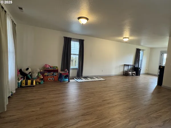 a view of a room with gym equipment and a large window