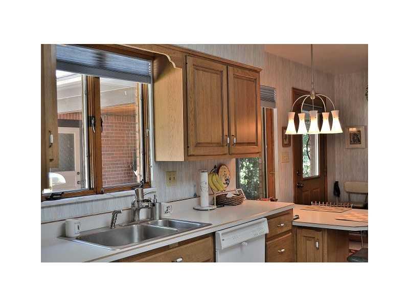426 Sangree Road Pittsburgh, PA 15237 - Photo 12 of 25 Kitchen. Over the sink windows allow for a great view of the rear yard. Enjoy breakfast and bird watching at the built-in counter. The rear door is the exit to the covered breezeway/patio and garage.