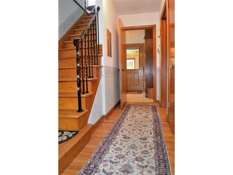 426 Sangree Road Pittsburgh, PA 15237 - Photo 16 of 25 Other. A hallway extends from the entry to the kitchen. Both first floor bedrooms and a full bath are to the right. Note the beautiful hardwood floors!
