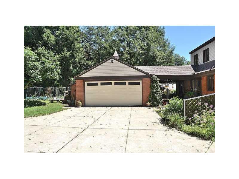 426 Sangree Road Pittsburgh, PA 15237 - Photo 22 of 25 Parking Lot/Garage. The concrete driveway extends to the extra-wide, extra high two-car garage, behind the house. The driveway is so large, it s a veritable parking lot!