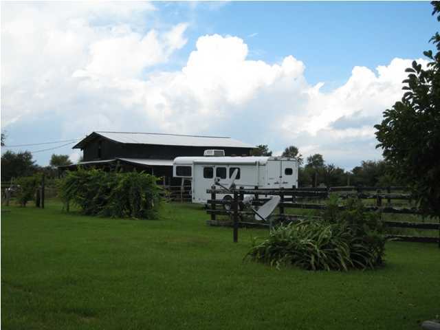 1517 Hester Church Road Baker, FL 32531 - Photo 20 of 28 a view of a house with backyard sitting area and garden