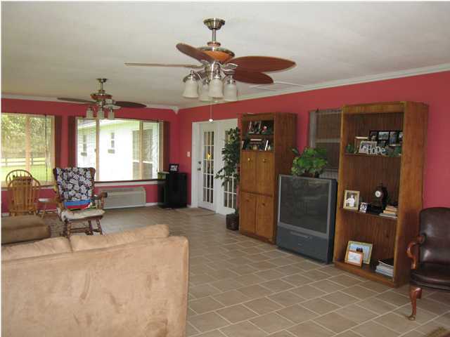 1517 Hester Church Road Baker, FL 32531 - Photo 3 of 28 a living room with furniture a chandelier and a window