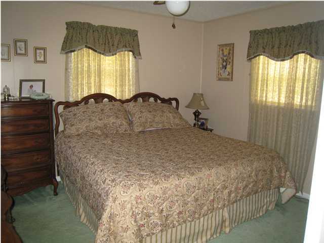 1517 Hester Church Road Baker, FL 32531 - Photo 8 of 28 a large bed sitting in a bedroom next to a window
