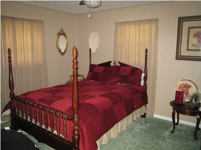 1517 Hester Church Road Baker, FL 32531 - Photo 9 of 28 a bed room with a bed window and a chandelier