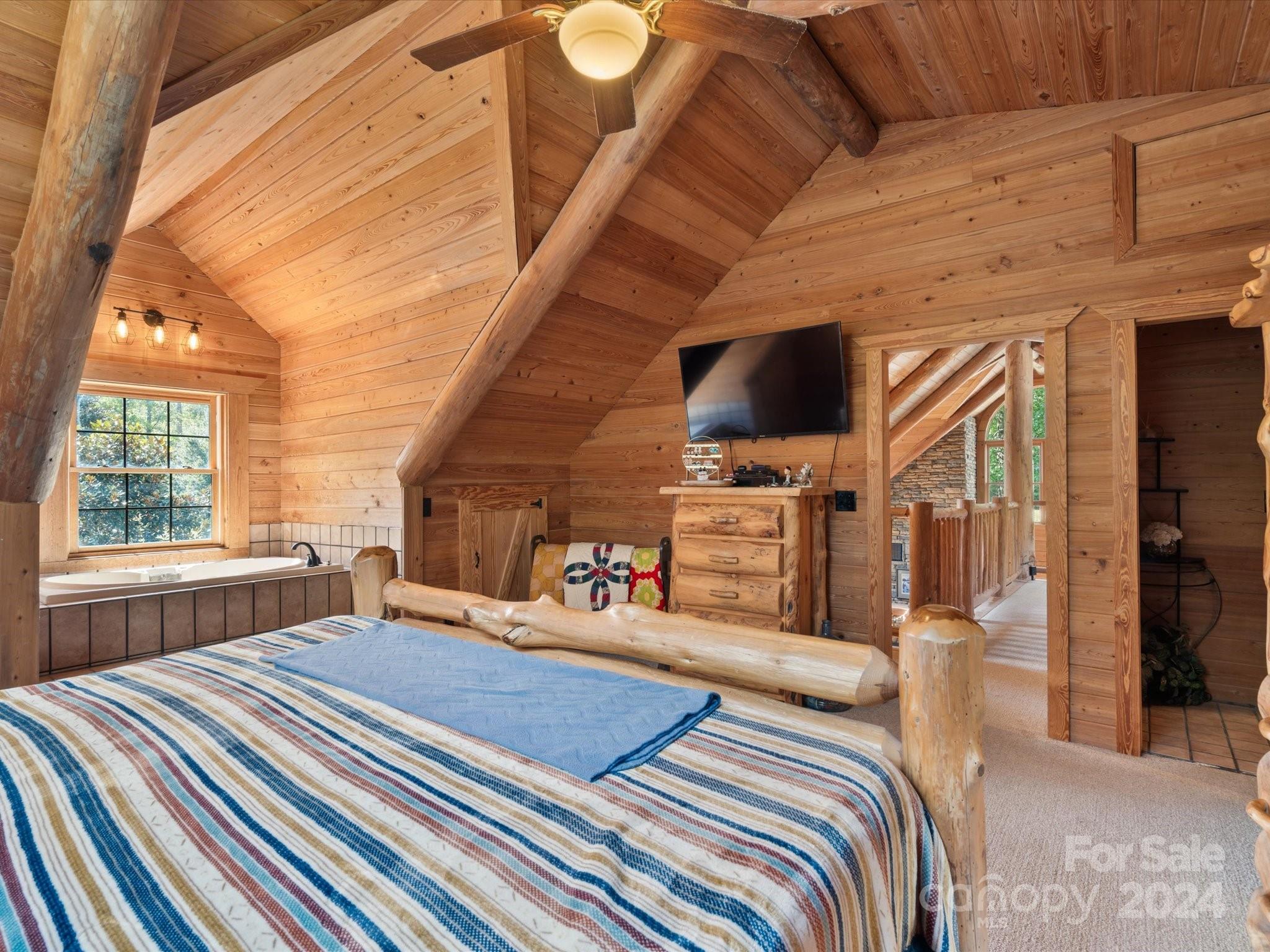 674 Ormond Road York, SC 29745 - Photo 19 of 48 a bedroom with a bed a flat screen tv and windows