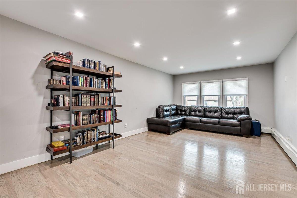28 Clark Avenue Edison, NJ 08817 - Photo 12 of 47 a living room with furniture and a book shelf