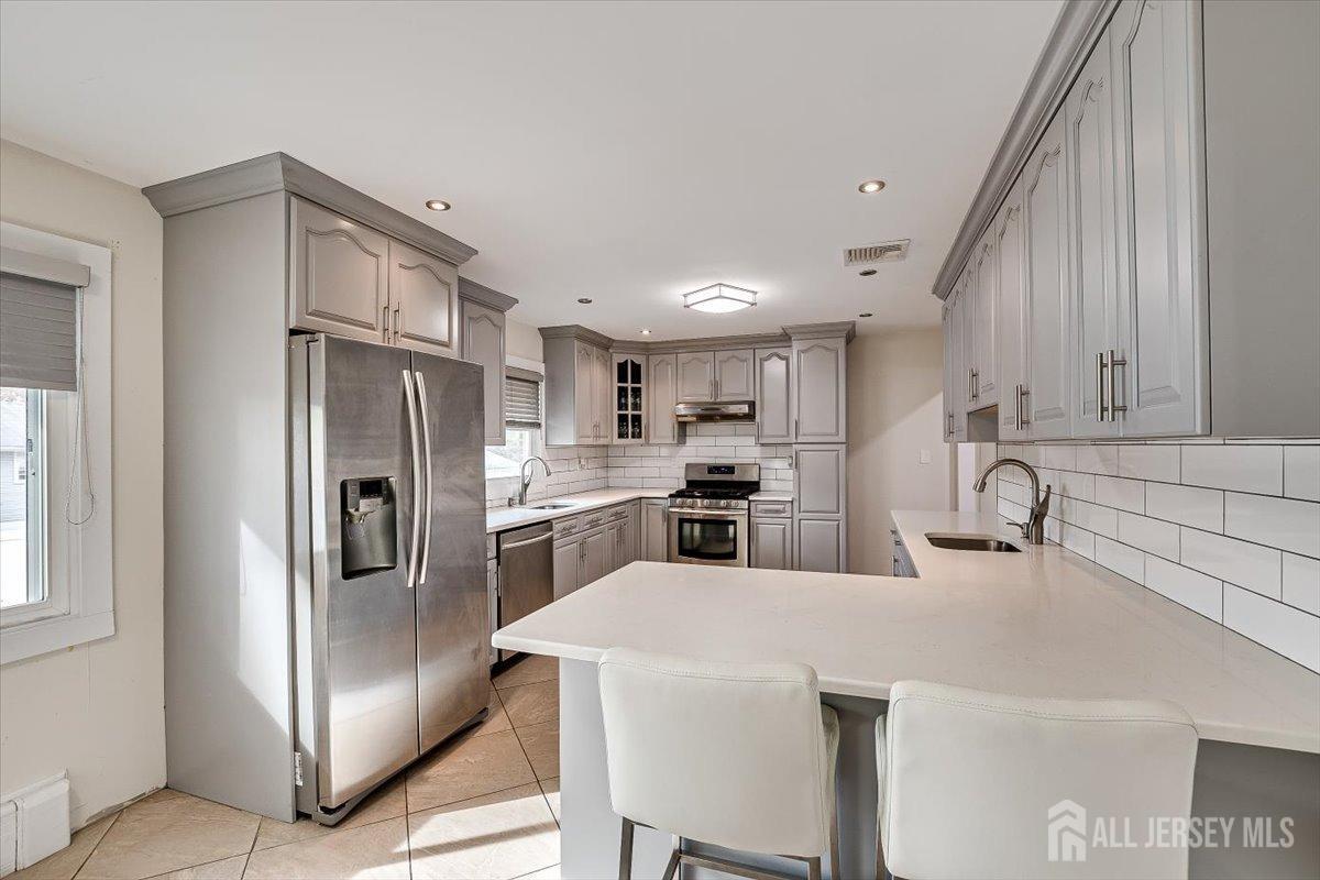 28 Clark Avenue Edison, NJ 08817 - Photo 19 of 47 a kitchen with refrigerator cabinets and a sink