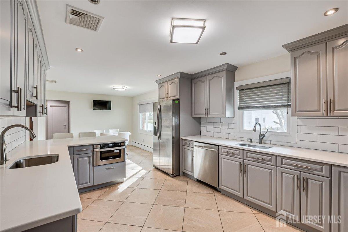 28 Clark Avenue Edison, NJ 08817 - Photo 23 of 47 a kitchen with stainless steel appliances granite countertop a sink stove oven and refrigerator