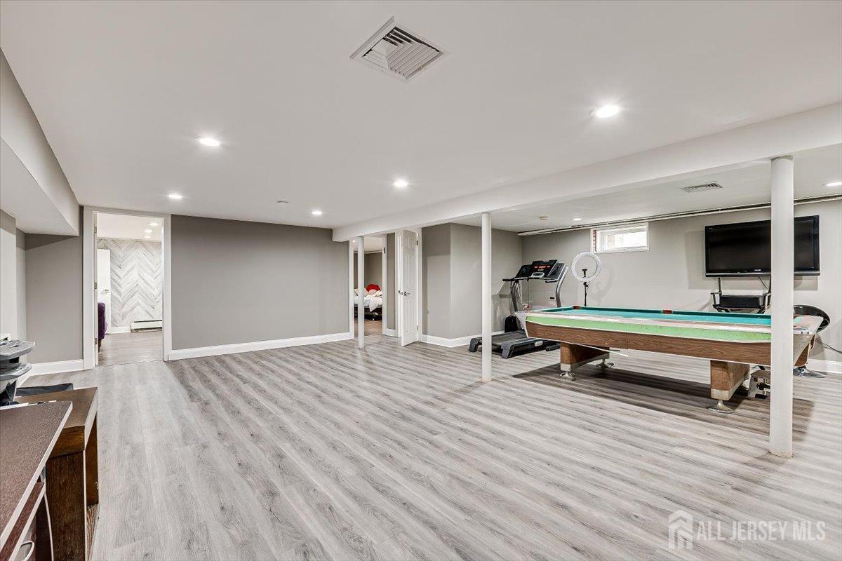 28 Clark Avenue Edison, NJ 08817 - Photo 35 of 47 a room with wooden floor and gym equipment
