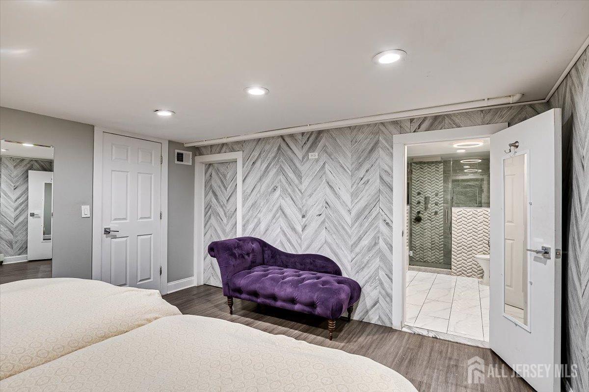 28 Clark Avenue Edison, NJ 08817 - Photo 40 of 47 a spacious bedroom with a bed and a couch