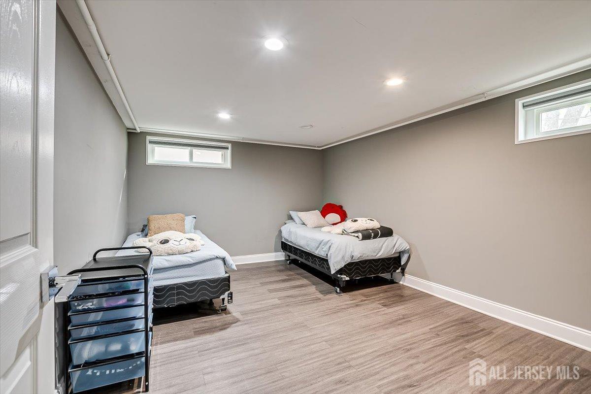 28 Clark Avenue Edison, NJ 08817 - Photo 43 of 47 a bedroom with a bed and wooden floor