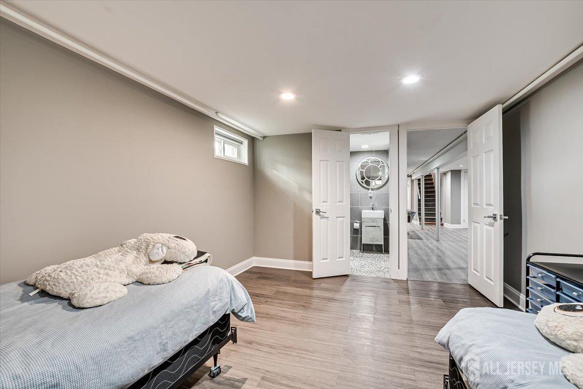 28 Clark Avenue Edison, NJ 08817 - Photo 44 of 47 a bedroom with a bed and wooden floor