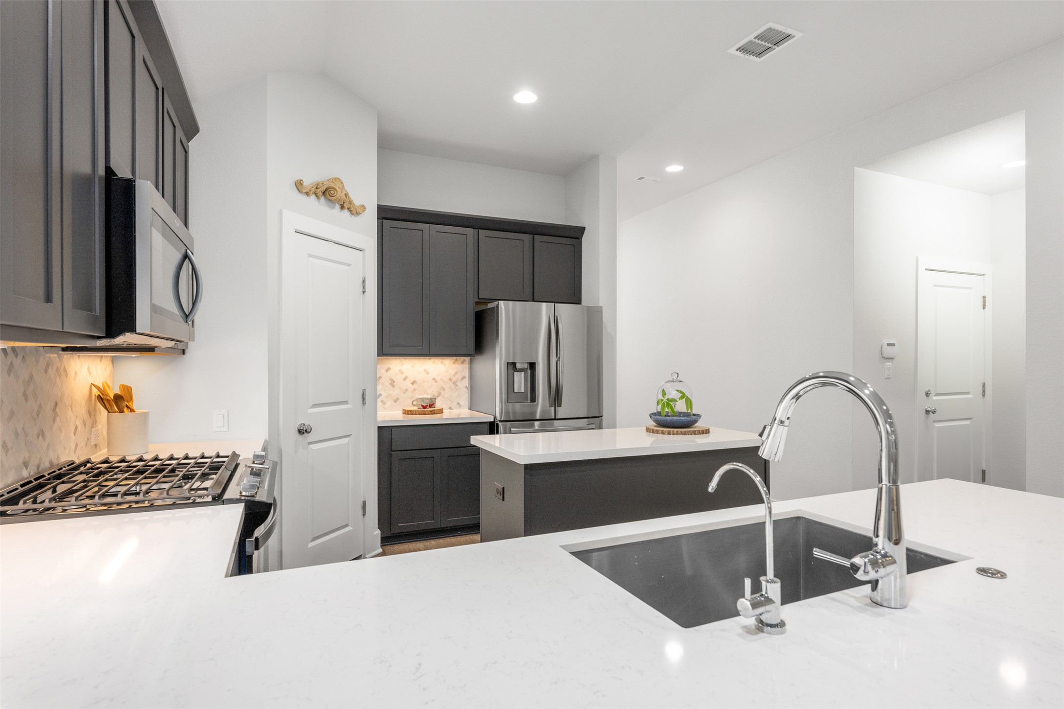 418 Raleigh Drive Georgetown, TX 78633 - Photo 13 of 39 a kitchen with stainless steel appliances granite countertop a sink and a refrigerator