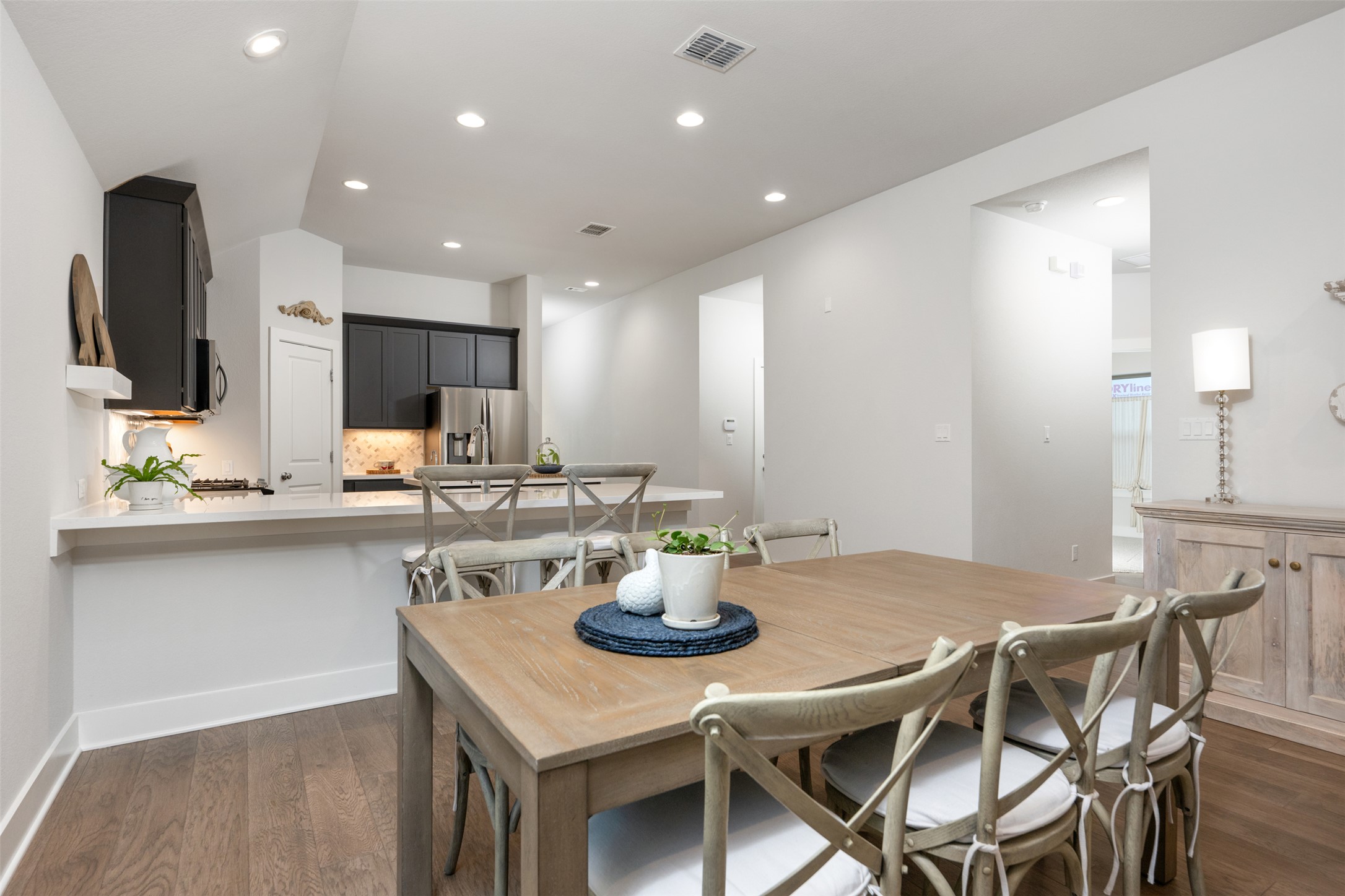 418 Raleigh Drive Georgetown, TX 78633 - Photo 19 of 39 a kitchen with stainless steel appliances kitchen island granite countertop a table and chairs in it