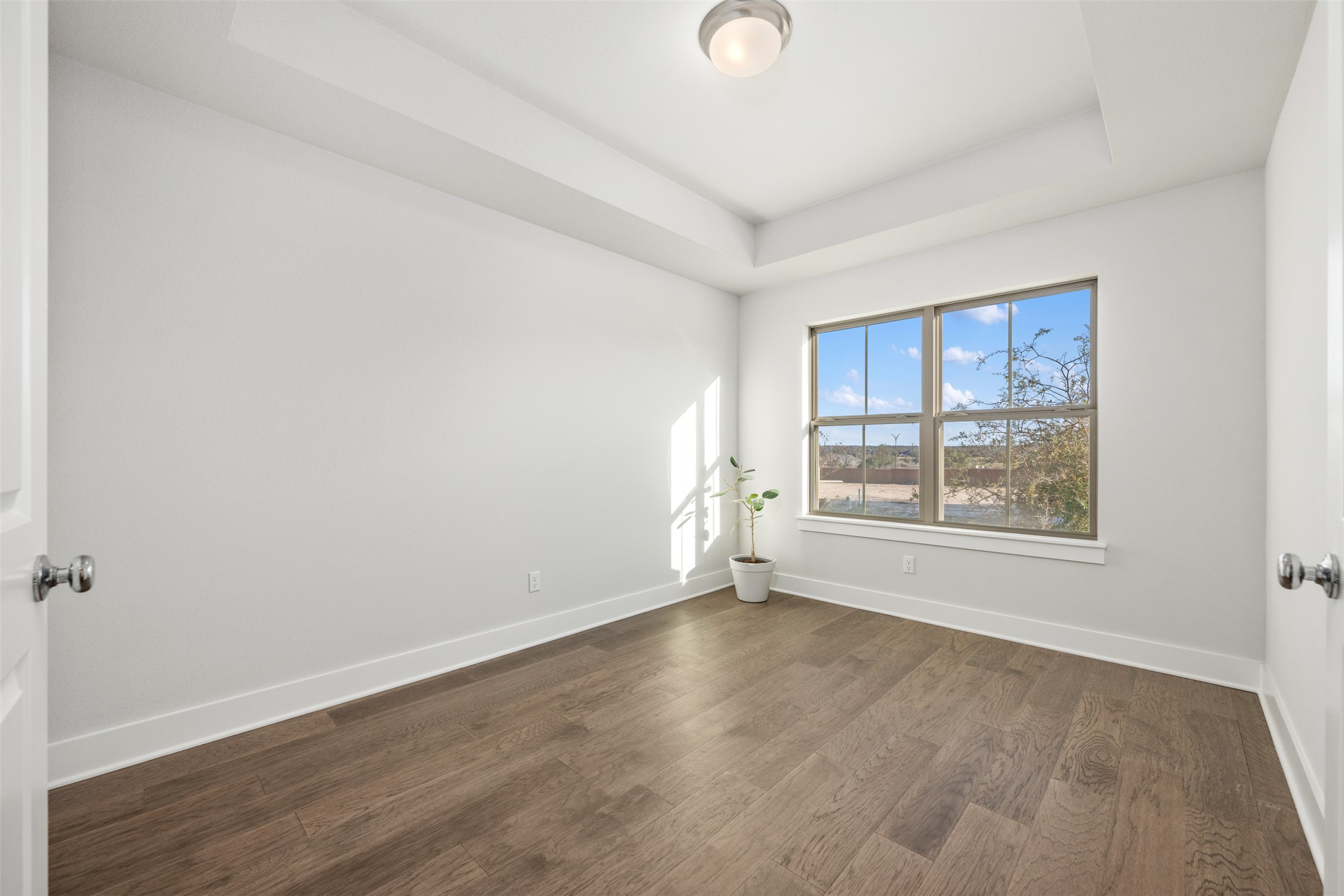 418 Raleigh Drive Georgetown, TX 78633 - Photo 7 of 39 an empty room with wooden floor and windows