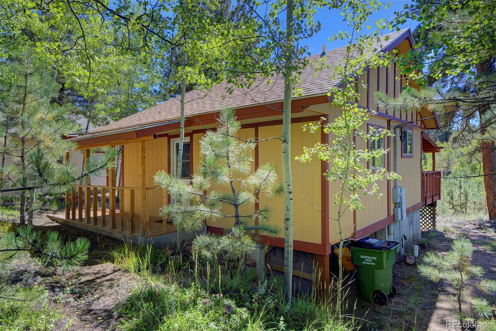 aerial view of a house with a yard and potted plants