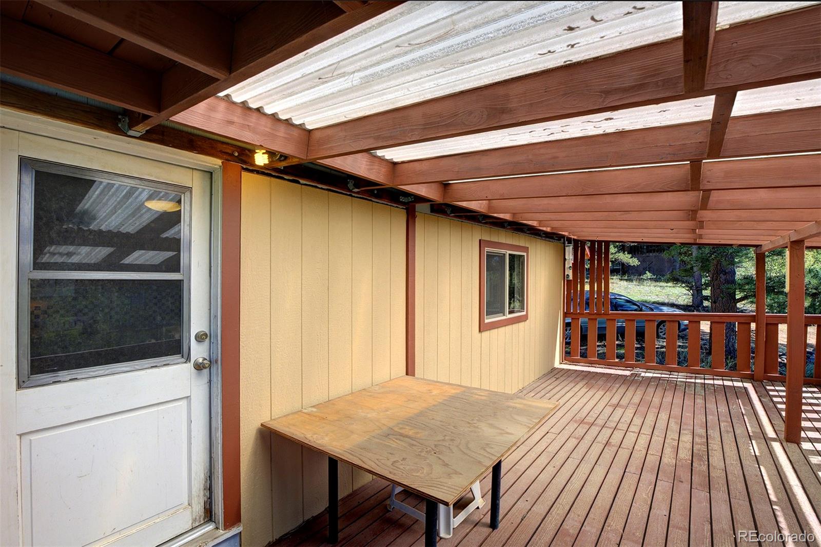 117 Tall Timber Lane Bailey, CO 80421 - Photo 13 of 37 a view of a backyard with a patio and wooden floor
