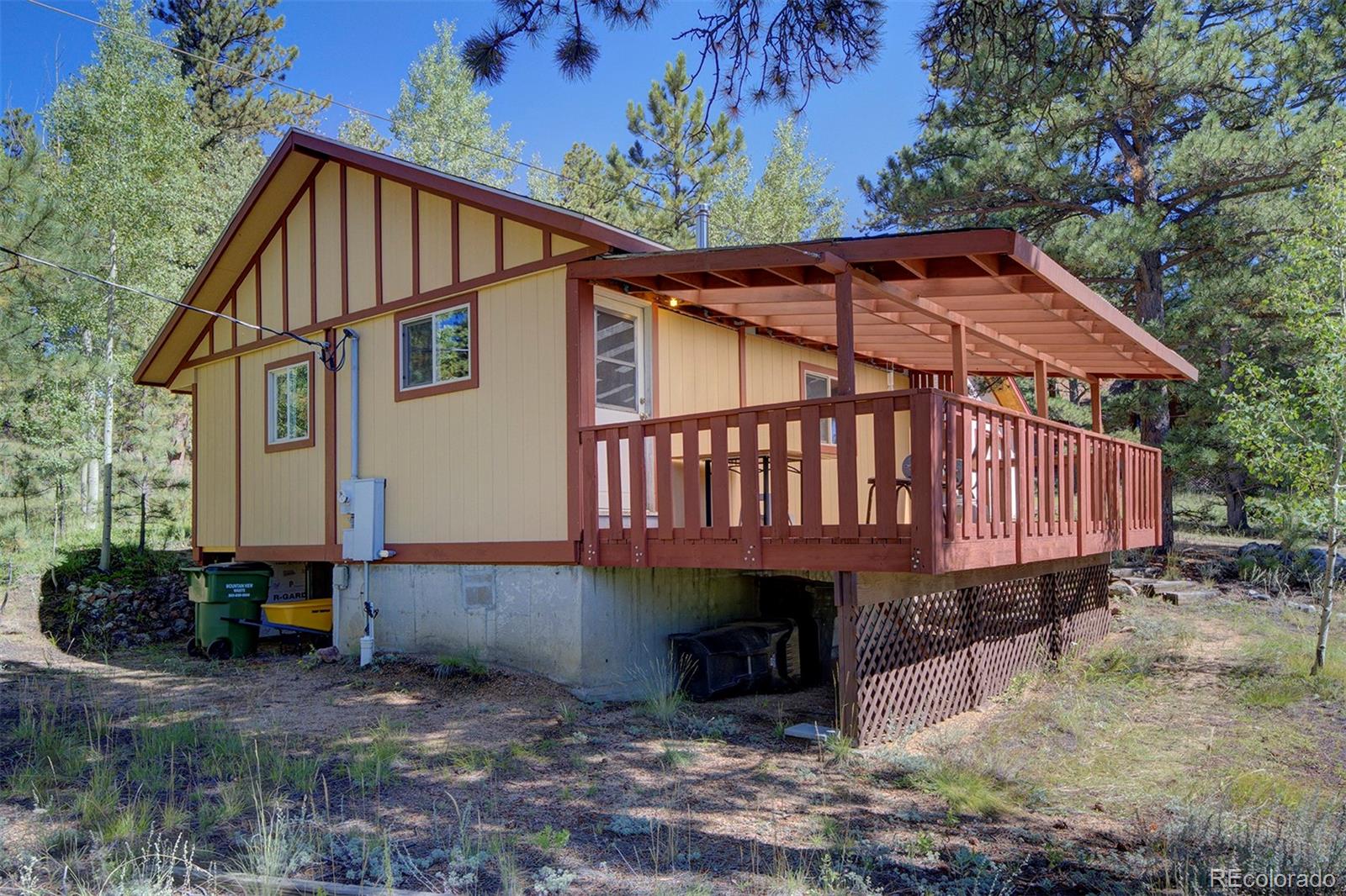 117 Tall Timber Lane Bailey, CO 80421 - Photo 15 of 37 a view of a small house with yard and sitting area