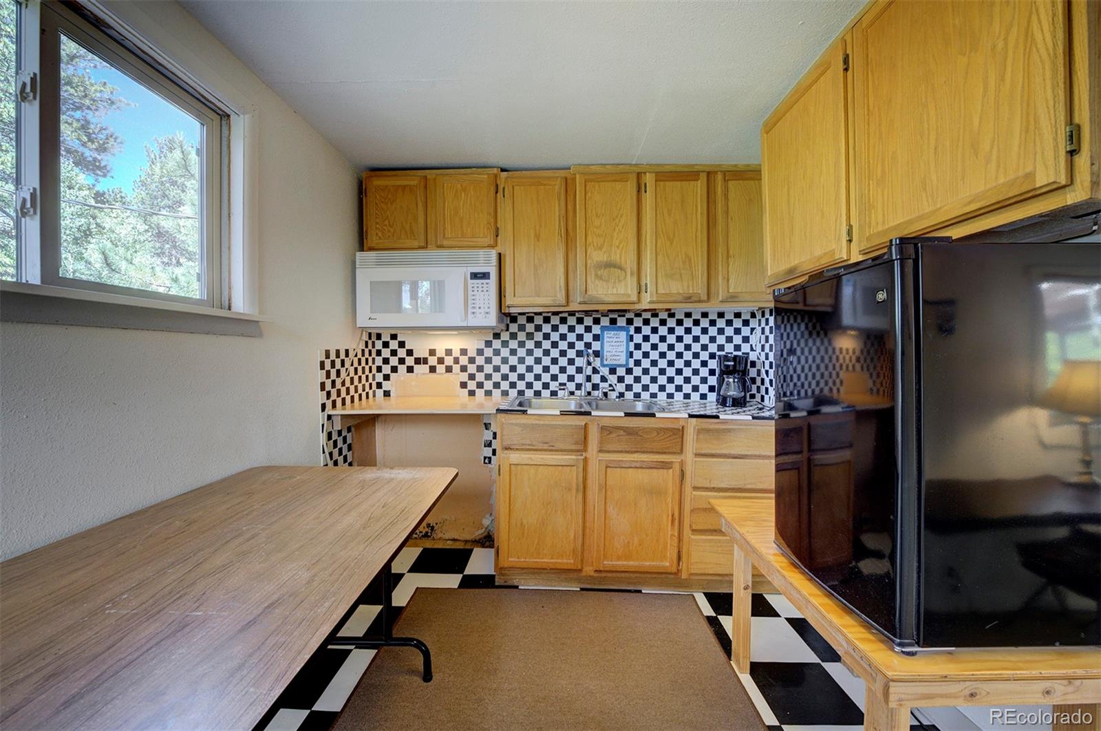 117 Tall Timber Lane Bailey, CO 80421 - Photo 18 of 37 a bedroom with a bed and wooden floor