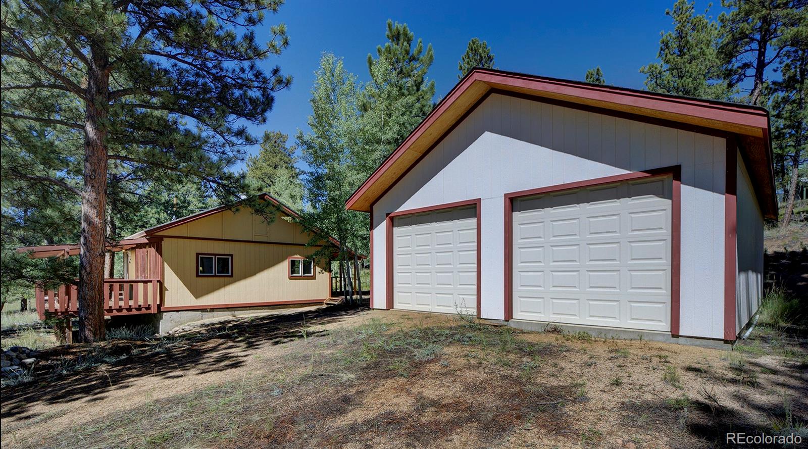 117 Tall Timber Lane Bailey, CO 80421 - Photo 22 of 37 a front view of a house with a yard and garage