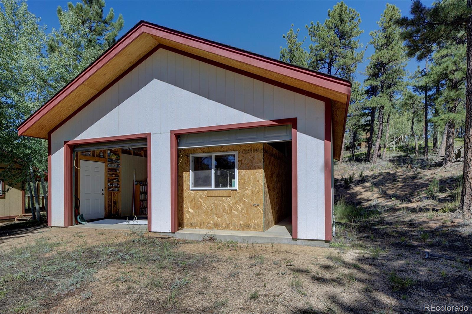 117 Tall Timber Lane Bailey, CO 80421 - Photo 24 of 37 a view of a house with a yard