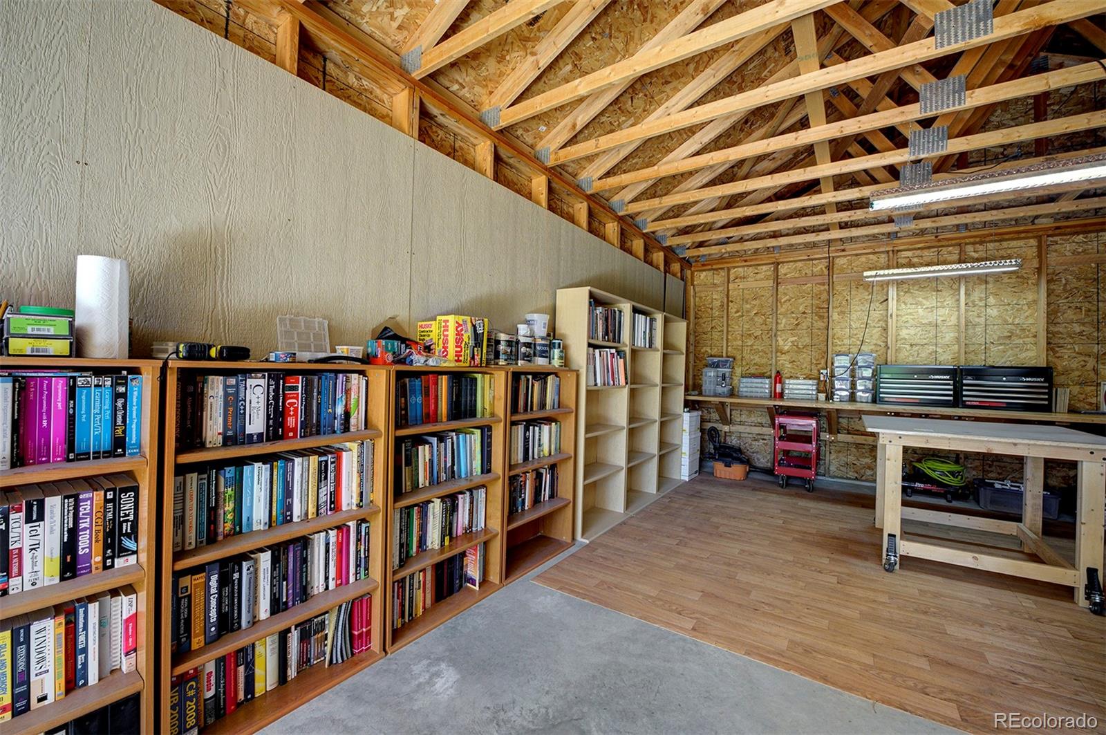 117 Tall Timber Lane Bailey, CO 80421 - Photo 32 of 37 a living room with a book shelf and a book shelf