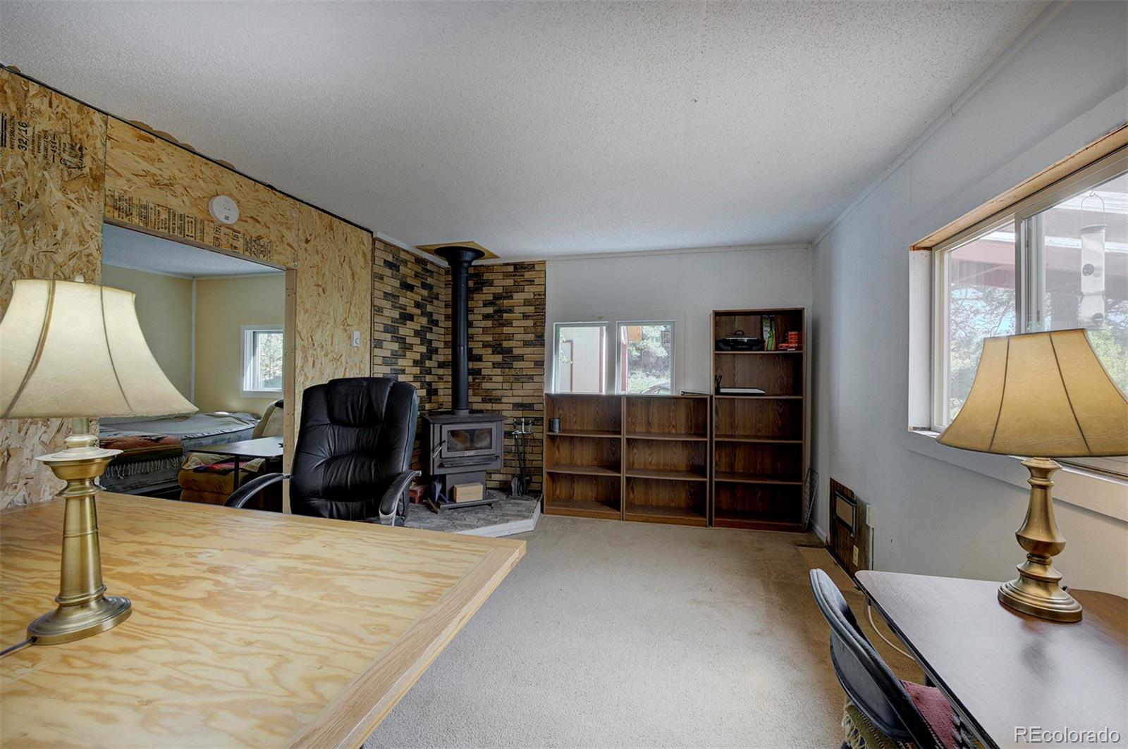 117 Tall Timber Lane Bailey, CO 80421 - Photo 6 of 37 a room with a wooden floor and furniture