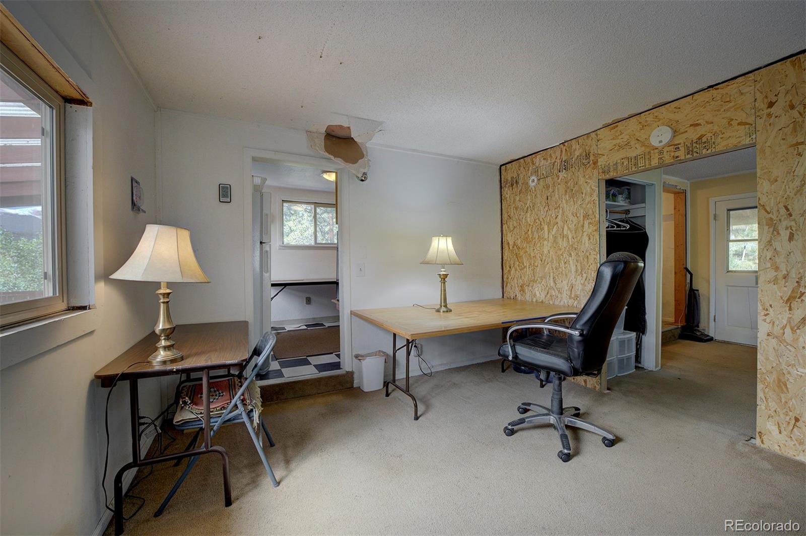 117 Tall Timber Lane Bailey, CO 80421 - Photo 7 of 37 a view of a workspace with furniture and a window