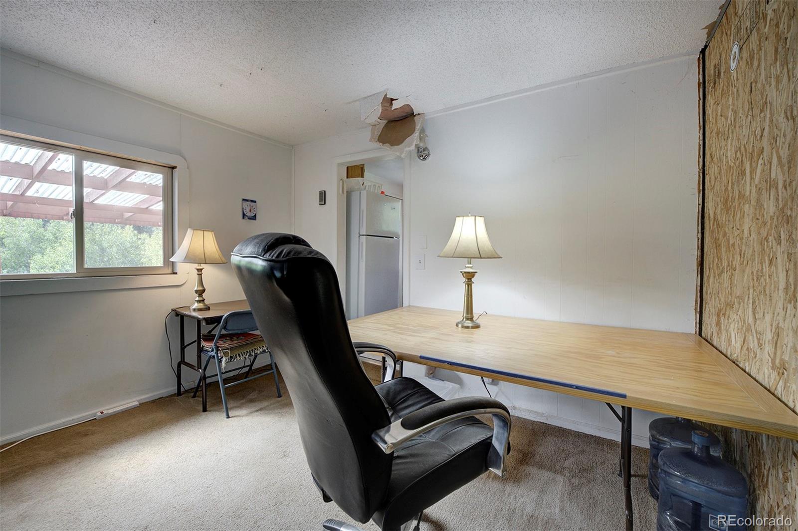 117 Tall Timber Lane Bailey, CO 80421 - Photo 8 of 37 a view of a workspace with furniture and a window