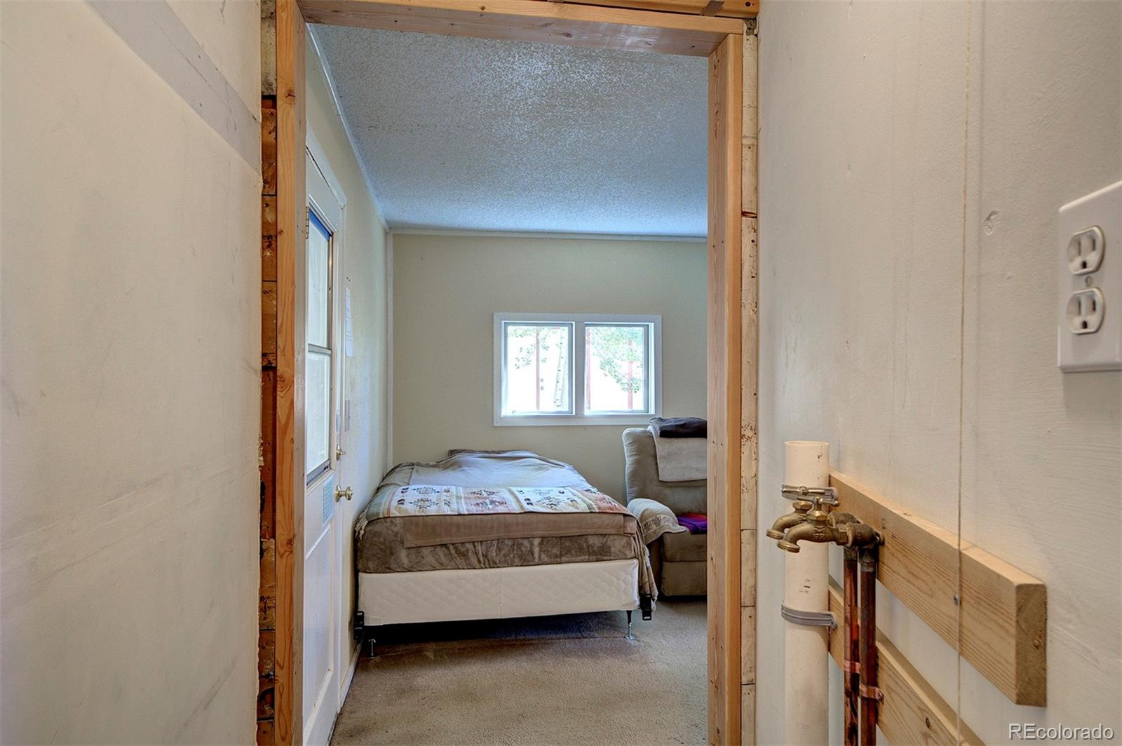 117 Tall Timber Lane Bailey, CO 80421 - Photo 9 of 37 a bedroom with a bed and a window