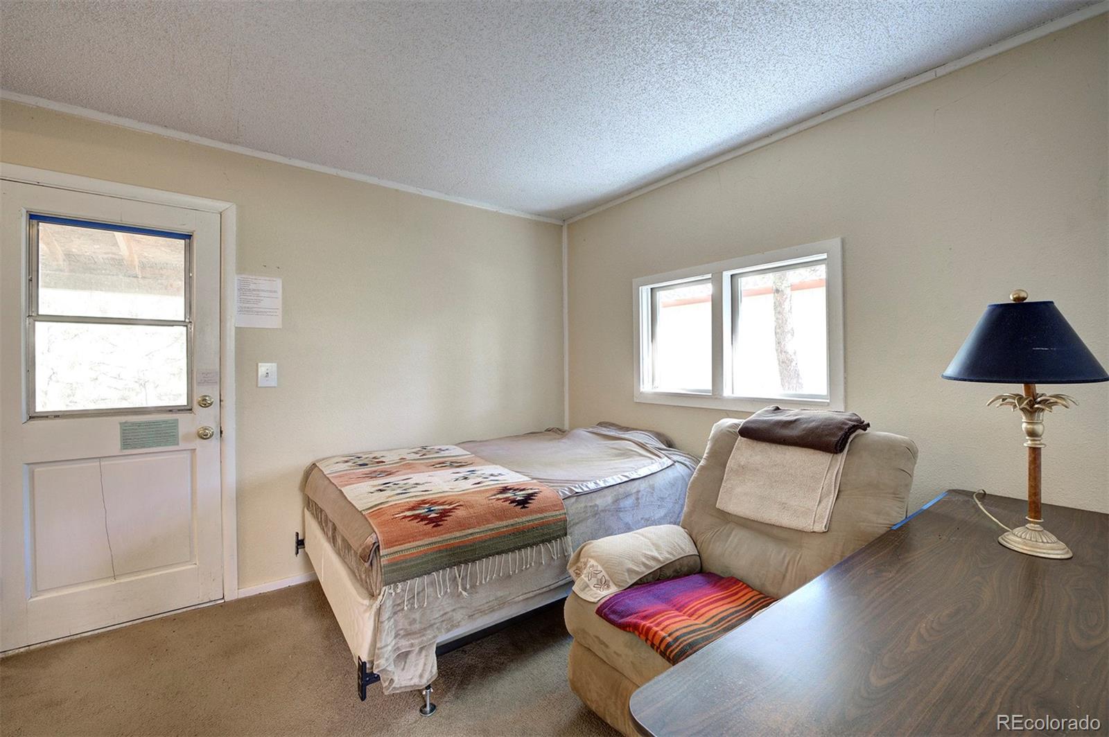 117 Tall Timber Lane Bailey, CO 80421 - Photo 10 of 37 a bedroom with furniture and a window