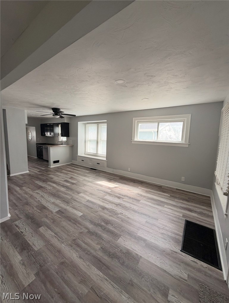 908 Palmyra Road Southwest Warren, OH 44485 - Photo 8 of 25 Wood-finish flooring, recessed lighting, and multiple windows with white trim