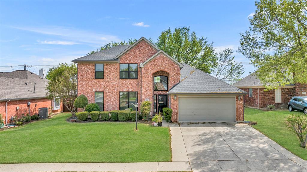 616 Monterey Drive Keller, TX 76248 - Photo 1 of 1 a front view of a house with a garden and plants