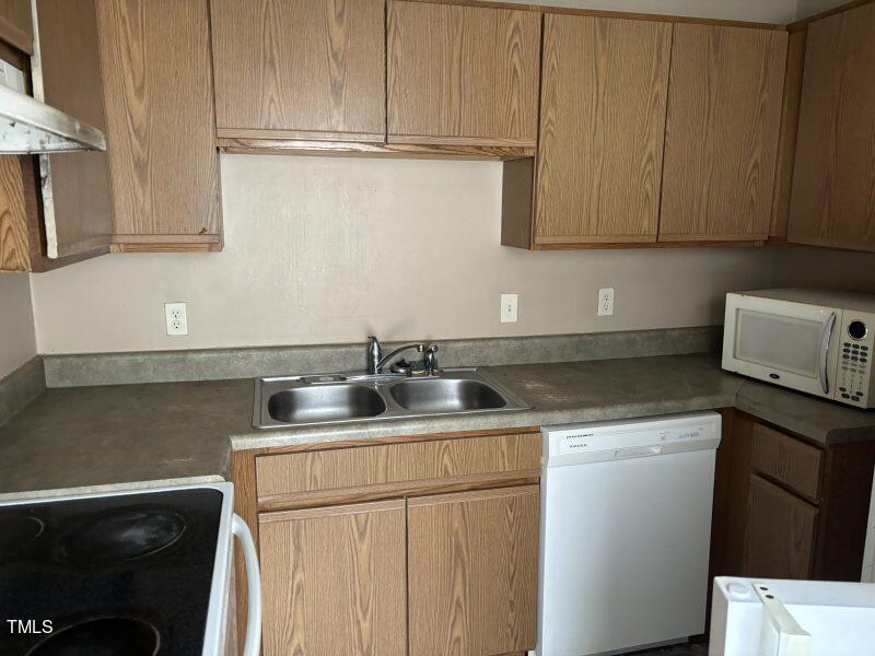 4724 Hoyle Drive Raleigh, NC 27604 - Photo 5 of 11 a kitchen with stainless steel appliances granite countertop a sink stove and cabinets