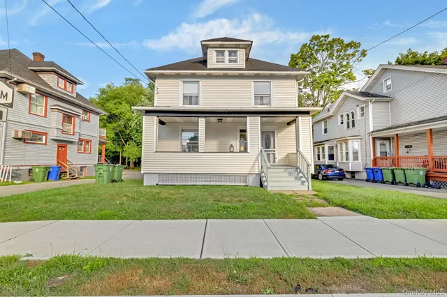 a front view of a house with a garden