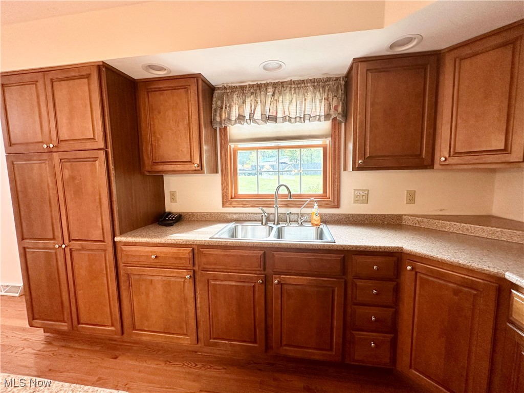 4461 Cross Creek Road Colliers, WV 26035 - Photo 6 of 33 Kitchen featuring brown cabinetry, light wood-type flooring, and light countertops
