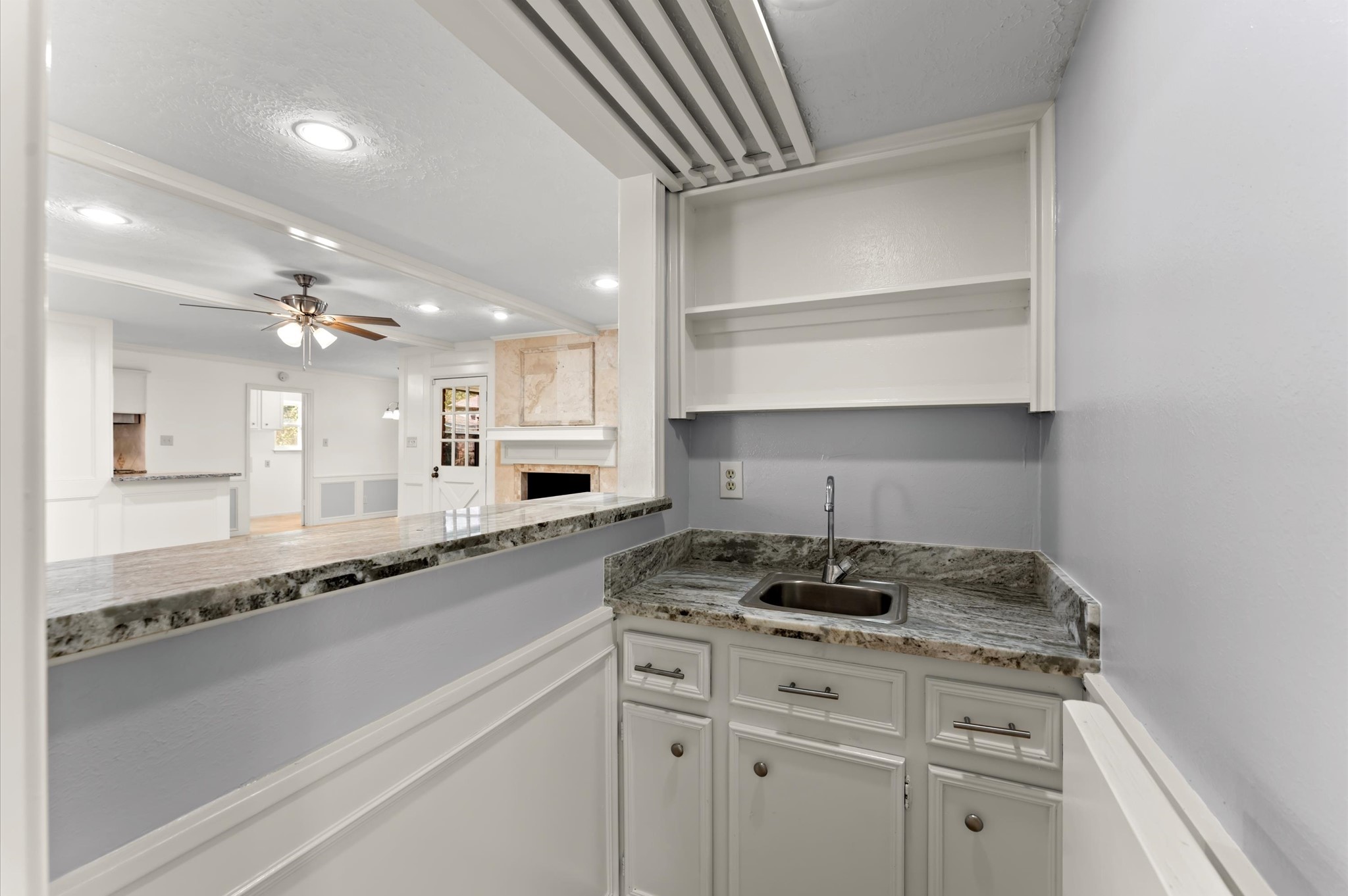 7311 17th Green Drive Humble, TX 77346 - Photo 14 of 32 a kitchen with a sink dishwasher a stove and white cabinets with wooden floor