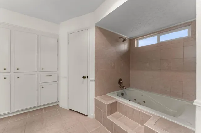 a bathroom with a bathtub a shower and a sink