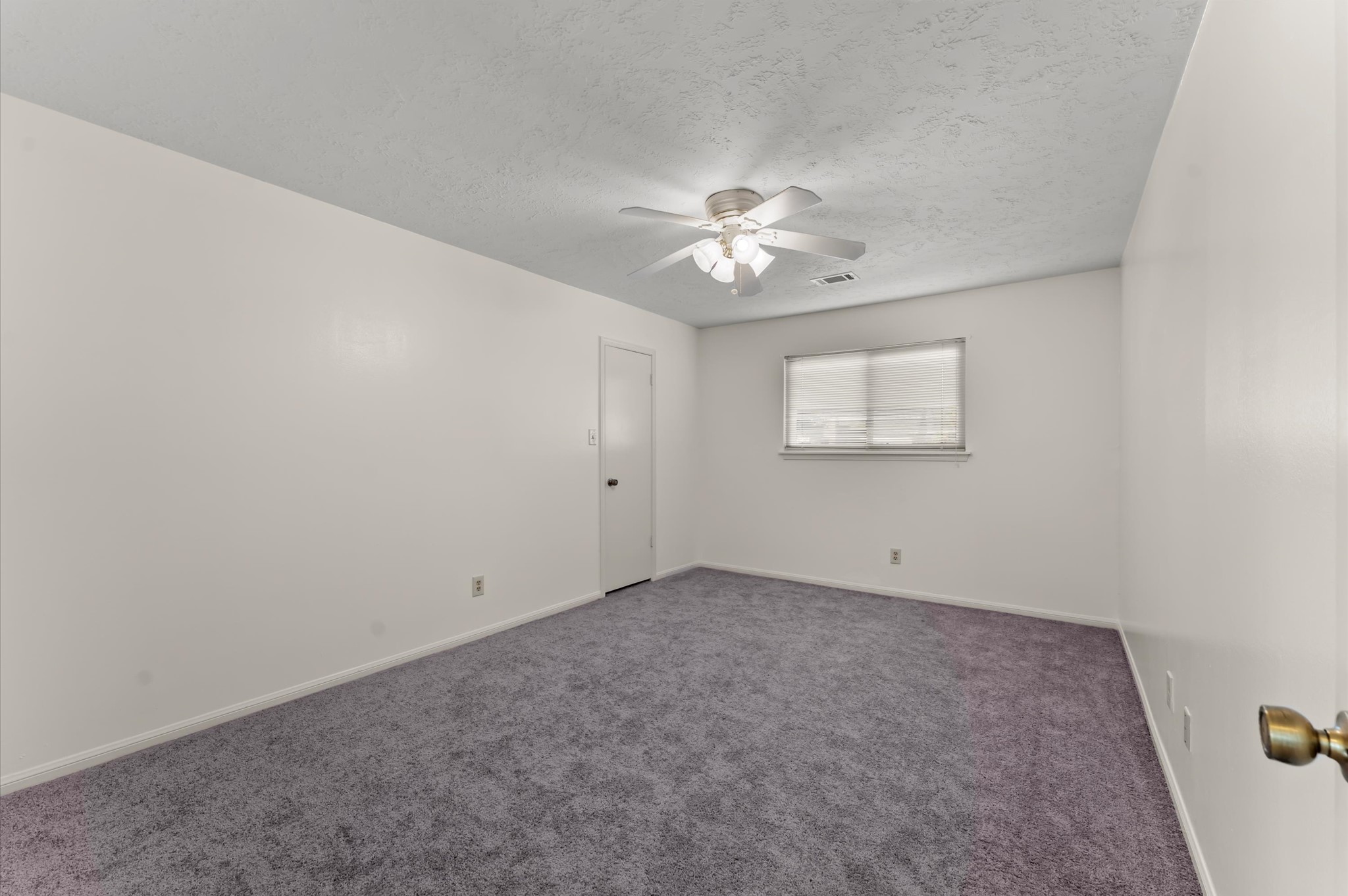 7311 17th Green Drive Humble, TX 77346 - Photo 24 of 32 an empty room with chandelier fan and windows