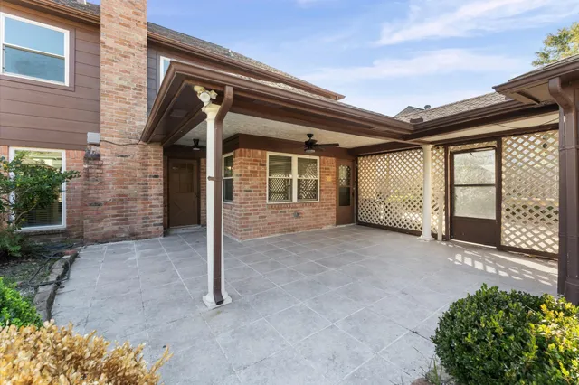 a view of a house with backyard and balcony