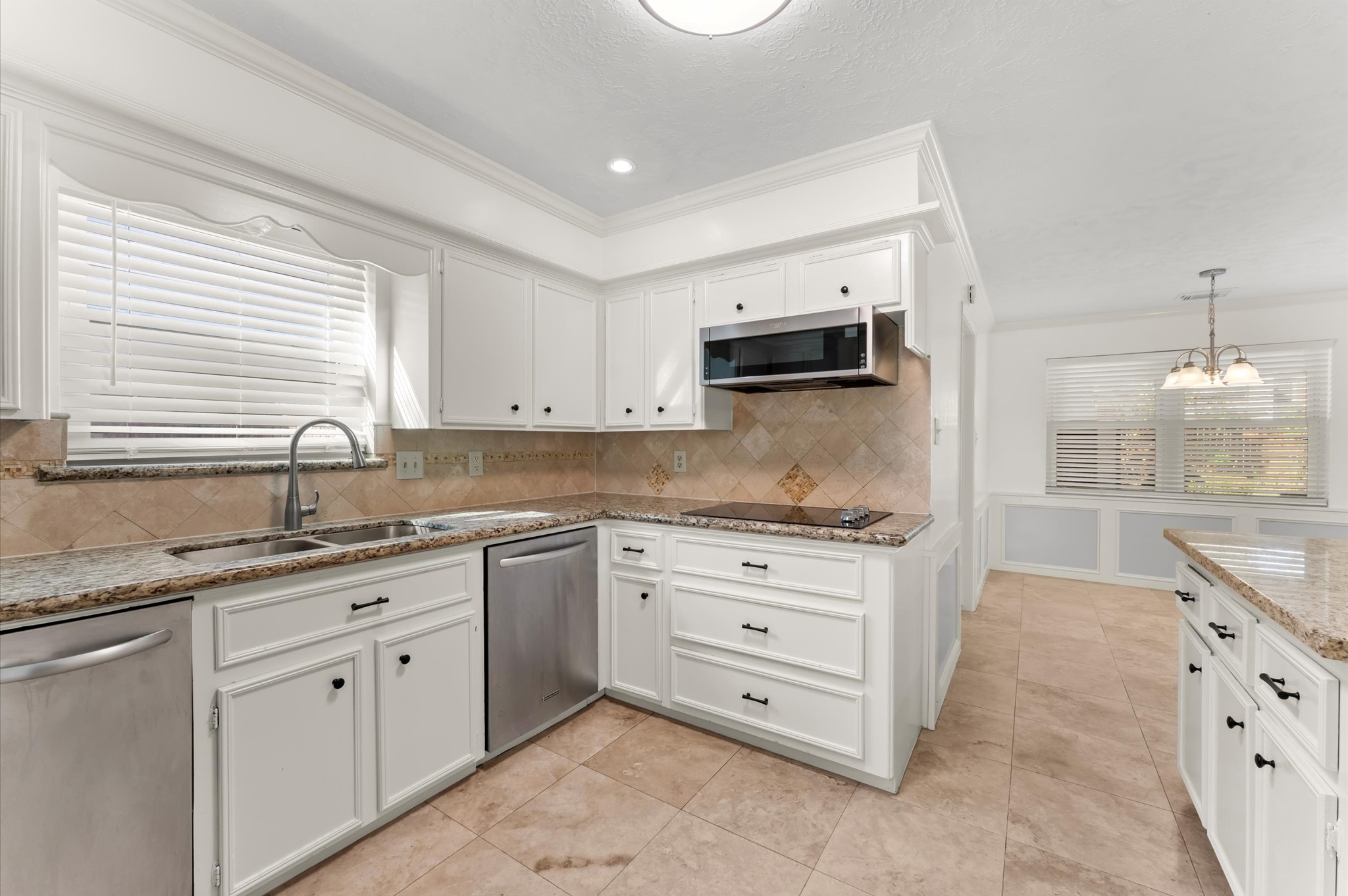7311 17th Green Drive Humble, TX 77346 - Photo 9 of 32 a kitchen with granite countertop a sink and cabinets