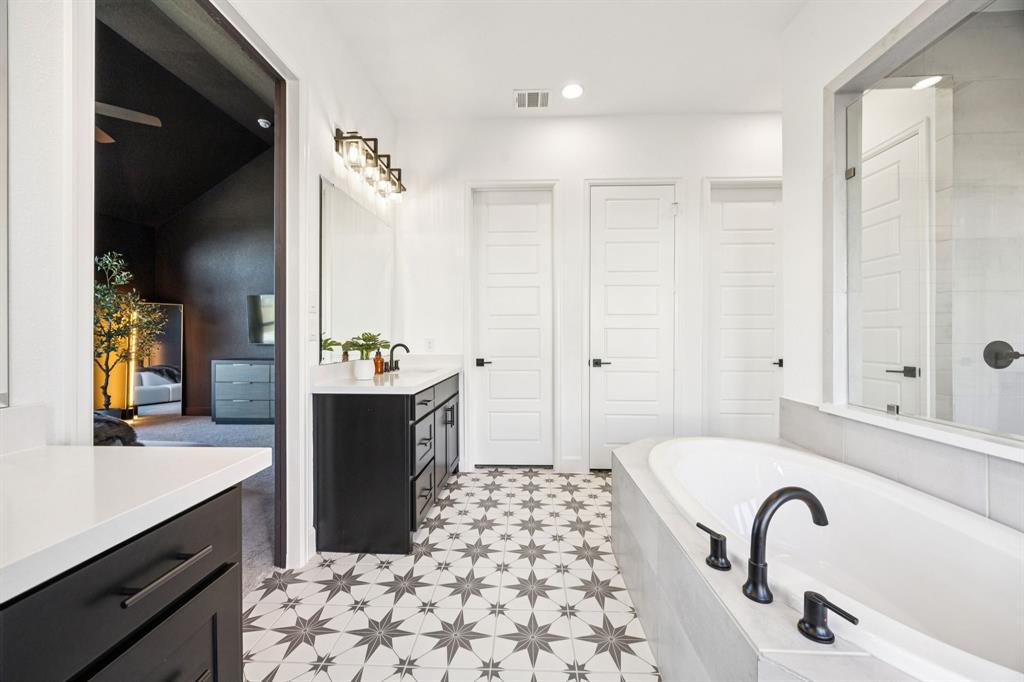 1551 Ripasso Way McLendon-Chisholm, TX 75032 - Photo 16 of 39 a bathroom with a bathtub sink and mirror