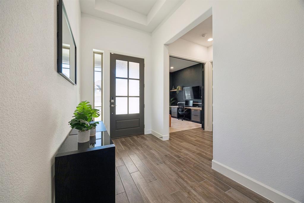 1551 Ripasso Way McLendon-Chisholm, TX 75032 - Photo 25 of 39 a view of an entryway with wooden floor and a potted plant